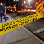 Los Angeles police tape at night crime scene.