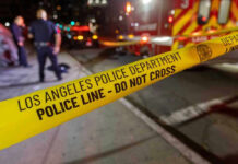 Los Angeles police tape at night crime scene.