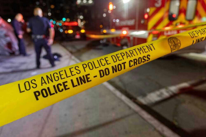 Los Angeles police tape at night crime scene.