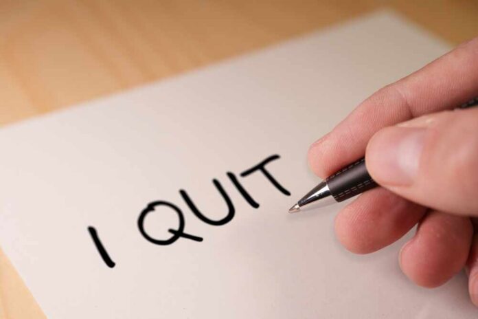 shutterstock_2465262527.jpg A hand writing 'I QUIT' on a piece of paper