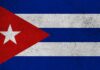 Cuban flag featuring red triangle, white stripes, and a star