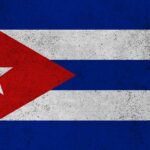 Cuban flag featuring red triangle, white stripes, and a star