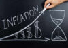 Chalkboard drawing of inflation with rising dollar symbols.