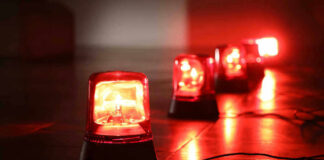 Red emergency lights on dark floor, illuminating the area.