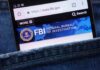 Mobile phone displaying the FBI website in a denim pocket