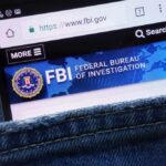 Mobile phone displaying the FBI website in a denim pocket