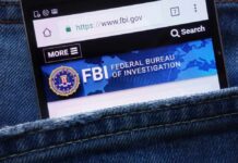 Mobile phone displaying the FBI website in a denim pocket