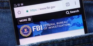 Mobile phone displaying the FBI website in a denim pocket