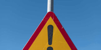 Triangular warning sign with exclamation mark.