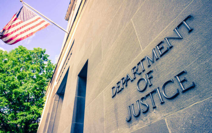 shutterstock_1384089728.jpg Department of Justice building with American flag.