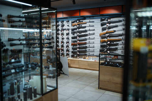 Interior of a gun shop showcasing various firearms on display