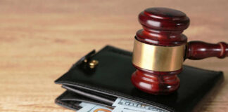 Gavel on wallet with visible dollar bills
