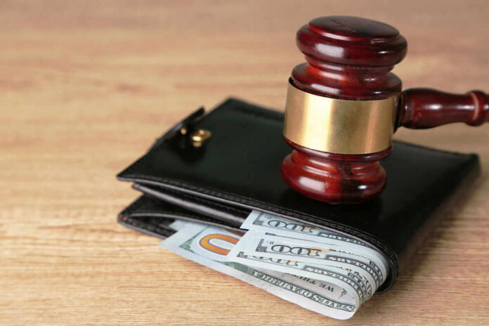 shutterstock_195469847.jpg Gavel on wallet with visible dollar bills