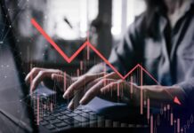 Epic Games Admits Shocking Financial Disaster Person typing on a laptop with a declining stock market graph overlay