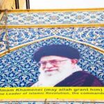 Mural of Ali Khamenei with decorative background and text