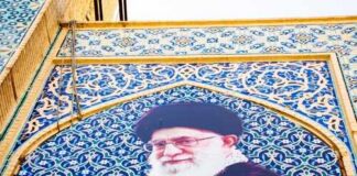 Mural of Ali Khamenei with decorative background and text