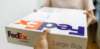 Person handing over a FedEx package to another individual