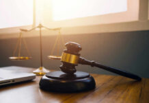 Gavel and scales of justice on desk.