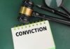 Christmas Gun Gift Triggers Murder Conviction A gavel resting on a notepad with the word 'CONVICTION' written on it