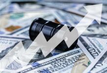 An oil barrel placed on a background of dollar bills with an upward trend graph overlay