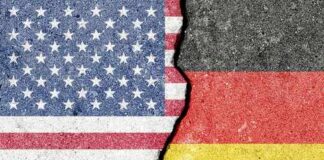 A cracked surface displaying the flags of the USA and Germany