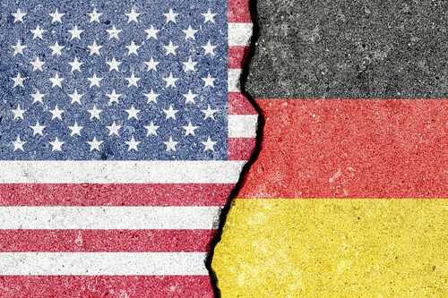 A cracked surface displaying the flags of the USA and Germany