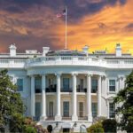 The White House with vibrant sunset sky.