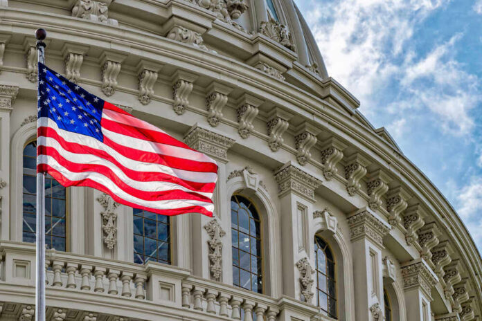 American flag in front of ornate building facade.