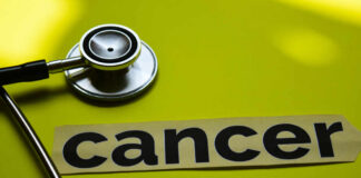 A stethoscope next to the word 'cancer' on a yellow background