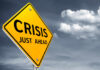 A yellow warning sign indicating a crisis ahead