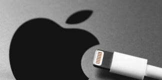 Apple logo next to white Lightning cable.