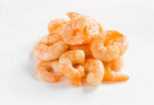 A pile of cooked shrimp on a white background