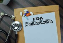 FDA document with pills and a stethoscope on a wooden surface