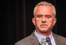 Robert F. Kennedy JR holding microphone.