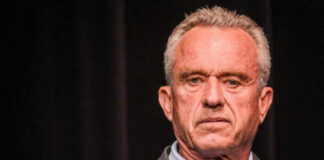 Robert F. Kennedy JR holding microphone.