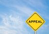 A yellow diamond-shaped sign with the word 'APPEAL' against a blue sky