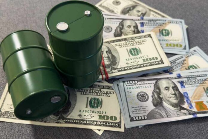 Two green oil barrels placed on a pile of hundred dollar bills