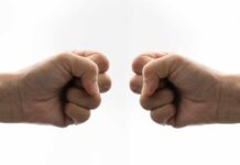 Fast-Food Value BATTLE: Chili’s vs McDonald’s Two fists facing each other in a gesture of camaraderie