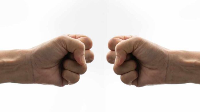 Two fists facing each other in a gesture of camaraderie