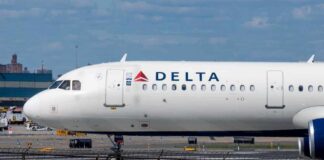 A Delta Airlines airplane on the runway at an airport