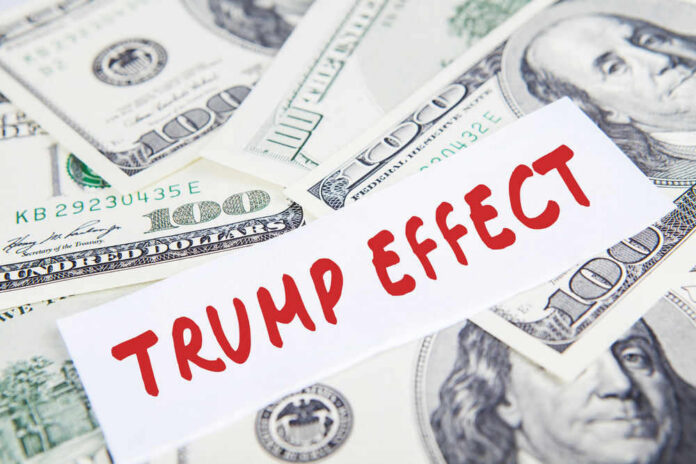 Text Trump Effect over hundred dollar bills