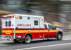 Shocking Tragedy: Mystery Engulfs Experts Red and white ambulance driving on a city street.