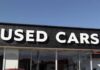 Used-Car Prices FINALLY Blink Signage of a used car dealership displaying 'USED CARS'