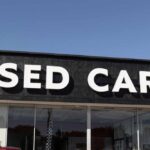 Used-Car Prices FINALLY Blink Signage of a used car dealership displaying 'USED CARS'