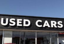 Signage of a used car dealership displaying 'USED CARS'
