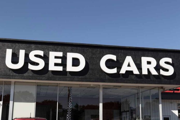 Signage of a used car dealership displaying 'USED CARS'