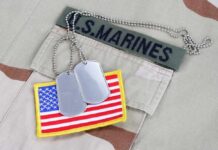 VIDEO: Marine DROPS Shooter — Mass Casualties Averted Close-up of military dog tags and an American flag patch on a US Marines uniform