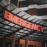 Tornado Emergency UNLEASHED — Dozens Injured Illuminated emergency sign at a hospital entrance