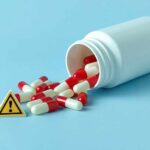 Weight Loss Drug BOMBSHELL — Hair Vanishing?! Spilled red and white capsules next to a warning sign