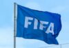 A blue flag with the FIFA logo waving in the wind